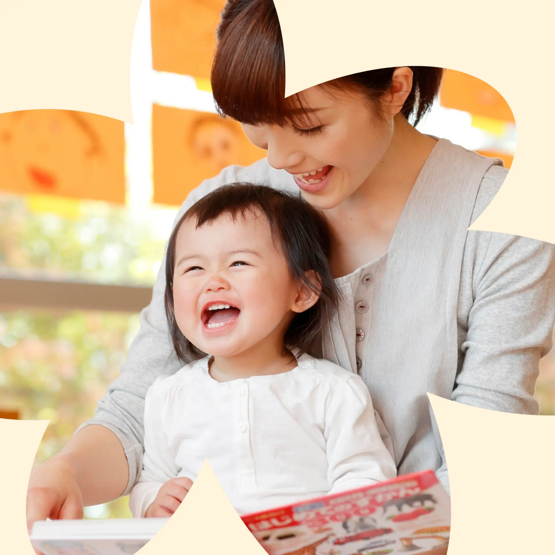 Educator smiling with two toddlers doing an art activity