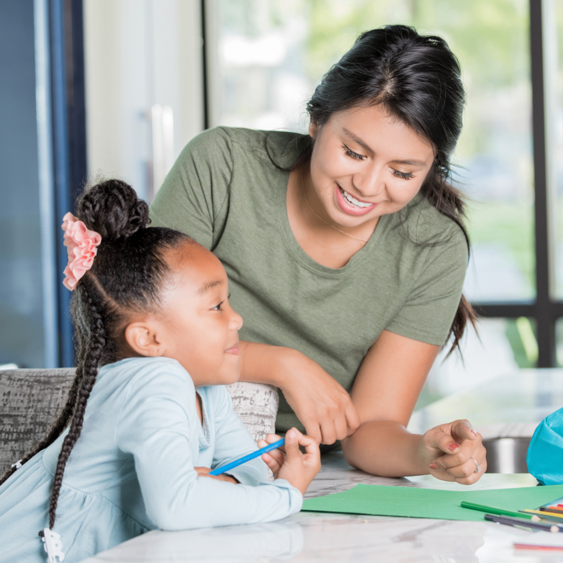 Live-out nanny preparing a healthy snack for a young child at home